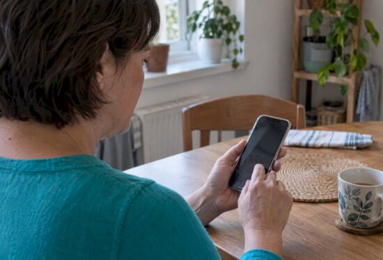 Caregiver adjusting settings on an iPhone