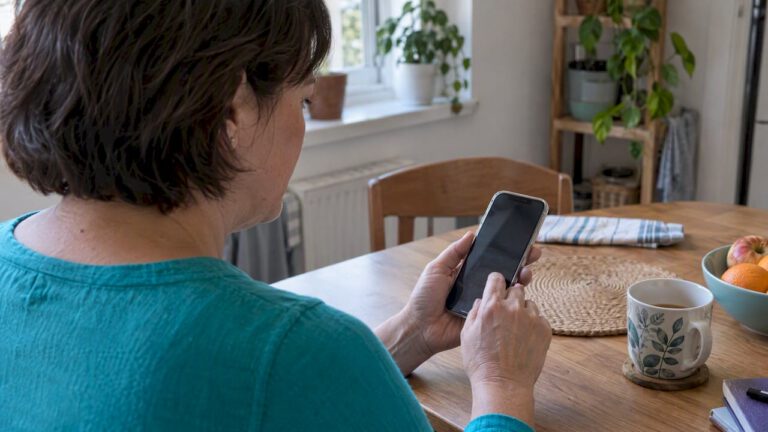 Caregiver adjusting settings on an iPhone